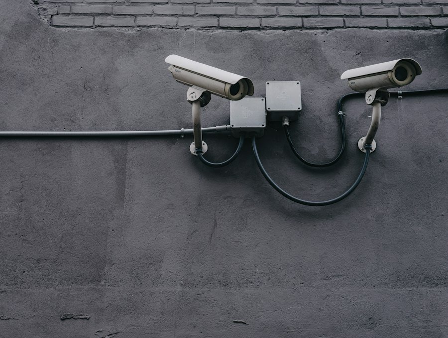 Two bullet surveillance cameras on a wall
