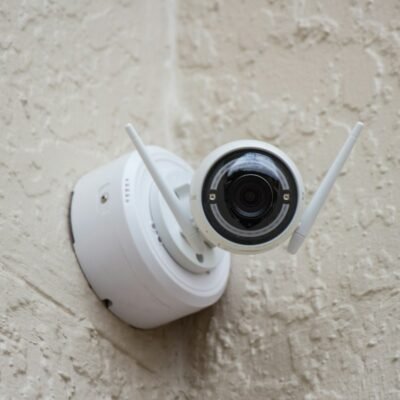 White surveillance camera on a wall